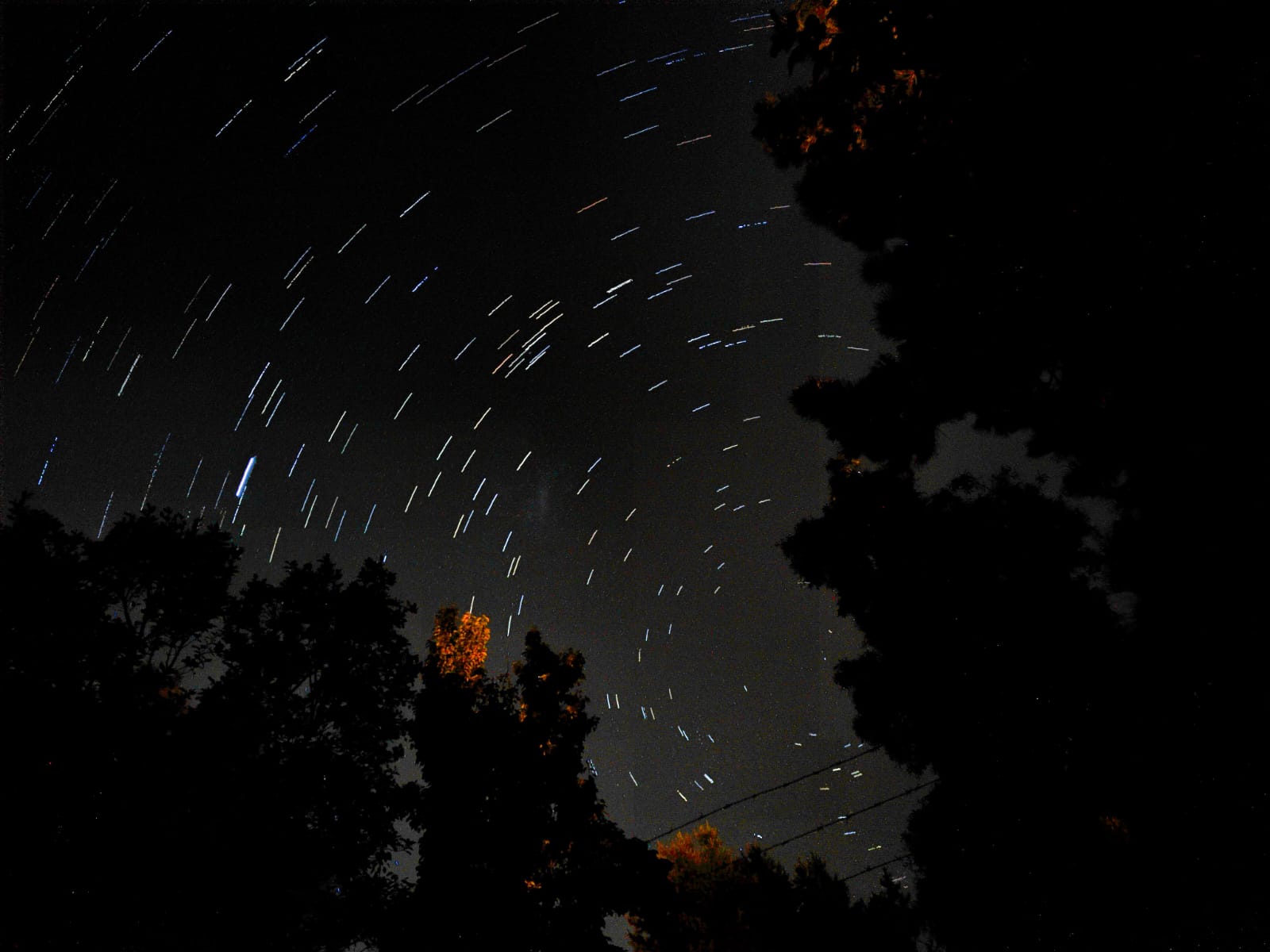 Long exposure photography showing star trails in the night sky